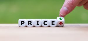 dice that spells out price with a hand turning the last one with a red and green arrow.