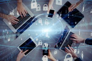 laptops, tablets, and phones all in a circle being used by people, with padlocks all around.