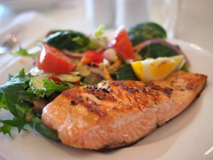 grilled salmon with vegetables on a plqte.