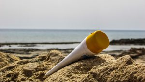 sunscreen tube on sand