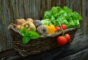 a variety of vegetables in a basket. 