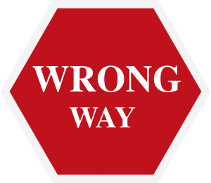 red sign with the words "wrong way" on it in white.