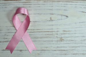 pink ribbon on a white wooden table