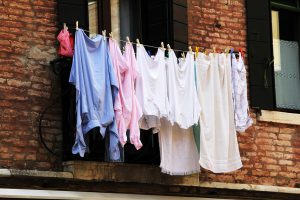 multiple laundry being hung outside. 