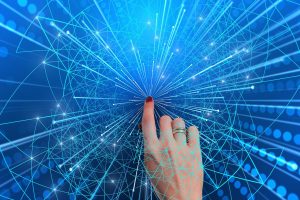 caucasian womans hand pressing into the middle of a blue network