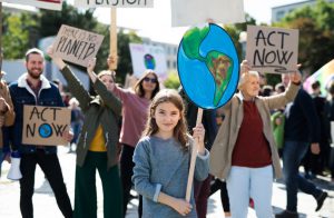 group of people with signs to act now against climate change