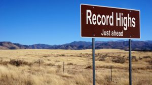 sign with record highs just ahead written on it with dessert in background.