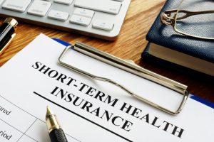short-term health insurance form on a clipboard