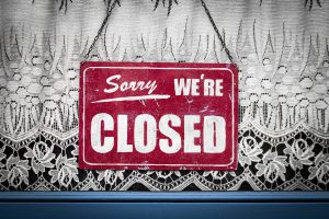 red sign with "sorry we're closed" in white