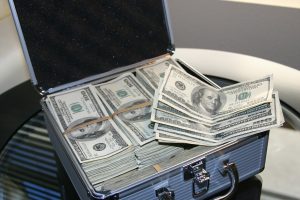 metal case filled with 100 bills in rubber bands.