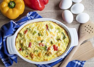quiche with eggs on a table and peppers 