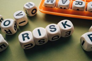 the word risk spelled out on scrabble dice