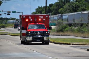 front of a red ambulance on the road