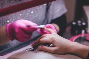 caucasian woman's hand getting a manicure