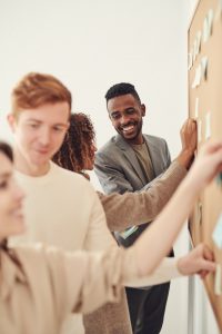 group of teens smiling and working together