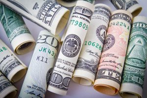 different money bills rolled up 