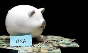 white piggy bank with money around it and a paper that says HSA