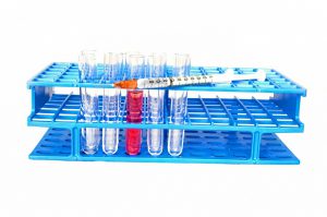 lab flasks in a tray with an syringe on top of the tray,