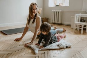 caucasian woman with child in the cobra position on the floor