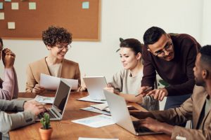 group of employees talking at a table.