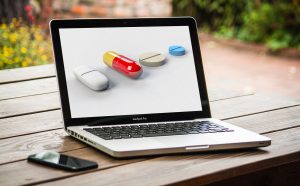 different types of pills on a laptop screen