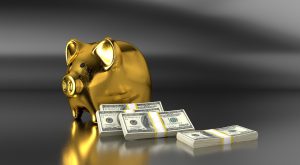 gold piggy bank with stacks of money next to it