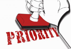 the word priority being stamped in red by a hand