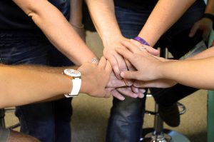 group of different hands one on top of each other