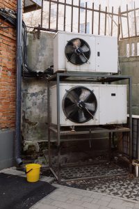 two white ventilation systems , one on top of another.