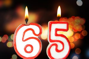 the numbers 65 as candles that are lit