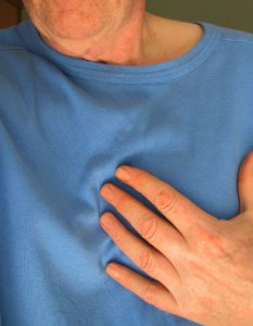 caucasian hand over the heart area.