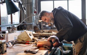 older caucasian man working on a saw table 