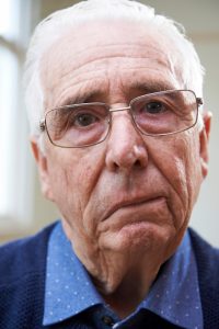 older caucasian man with one side of his face drooping