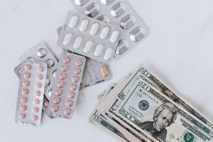 money on a table near some prescription medications