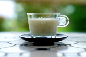 glass cup with a light brown liquid in it