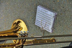 trombone with a musical sheet in front of it