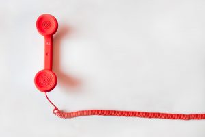 red phone ear piece with red cord connected.