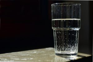 glass of water with tiny bubbles in it