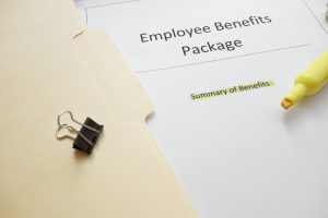 paper in folder that says employee benefits package with a highlighter