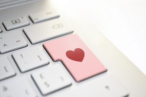 a red heart on a pink keyboard button