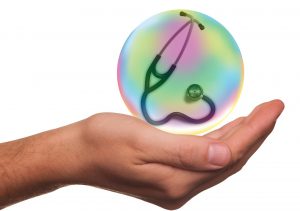 caucasian hand with a bubble over it with a stethoscope in the bubble.