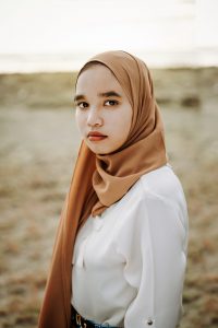 young asian woman with a hijab around her hair and neck