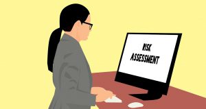 illustration of a woman in business attire looking at a computer screen that says "risk assessment" on it