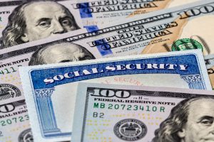 social security card with hundred dollar bills surrounding it