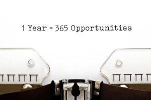 typewriter with the words "1 year=365 opportunities" written in the middle