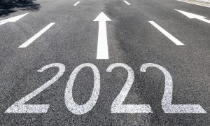 the number 2022 on the road with an arrow in front of it going up.