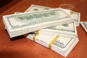 hundred dollar bills in stacks on top of each other.