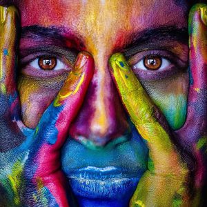 face of a woman with different colors all over it.