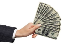 caucasian female hand holding up hundred dollar bills.
