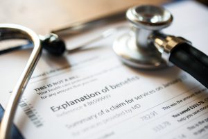 stethoscope on top of a piece of paper that says explanation of benefits.